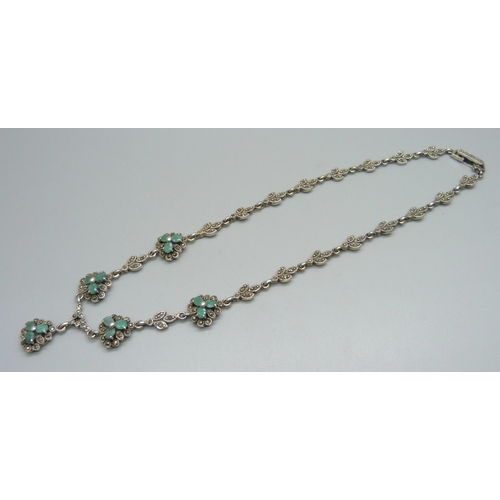 1009 - A silver necklace set with green stones and marcasite (some marcasite missing), 48g