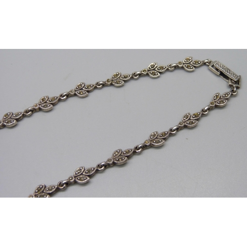 1009 - A silver necklace set with green stones and marcasite (some marcasite missing), 48g