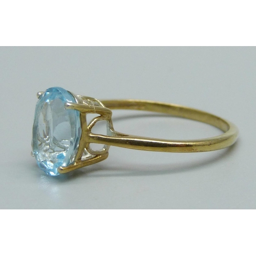 1030 - A silver gilt and blue stone solitaire ring, Q