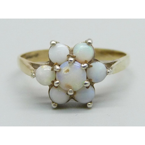 1034 - A silver gilt and opal cluster ring, Q, centre stone a/f