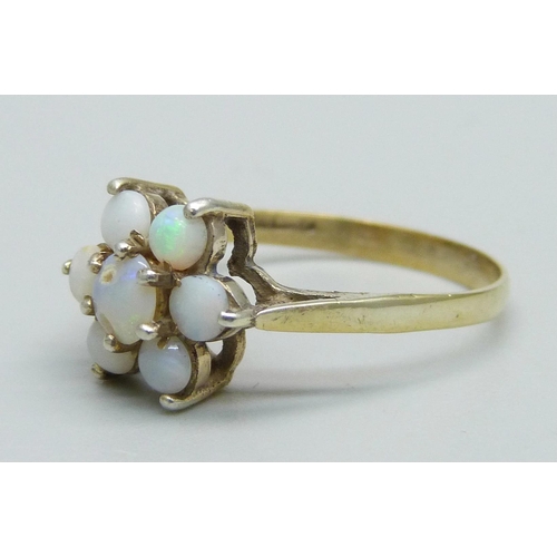 1034 - A silver gilt and opal cluster ring, Q, centre stone a/f