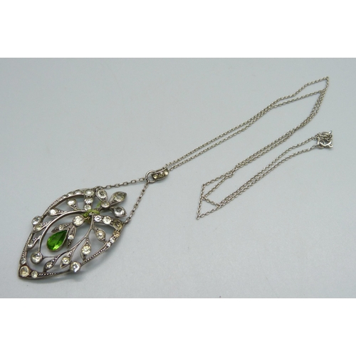 1037 - A white metal and stone set pendant and chain, drop requires repair