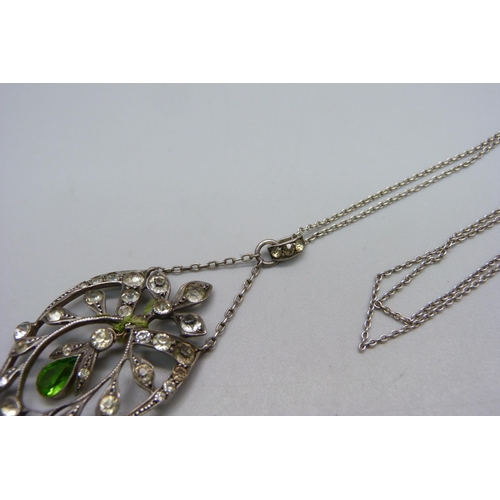 1037 - A white metal and stone set pendant and chain, drop requires repair