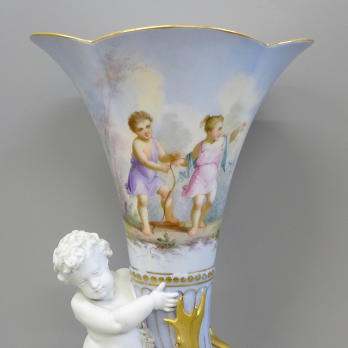 607 - A hand painted porcelain vase with putti holding the vase with stag opposite with gold decoration, p... 