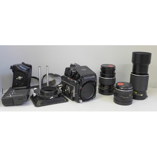 739 - A Mamiya 645 1000s medium format film camera with three lenses; 210mm, 150mm, 80mm, a range of filte... 