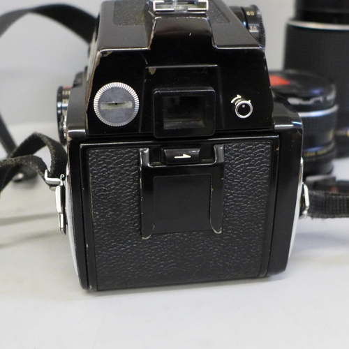 739 - A Mamiya 645 1000s medium format film camera with three lenses; 210mm, 150mm, 80mm, a range of filte... 