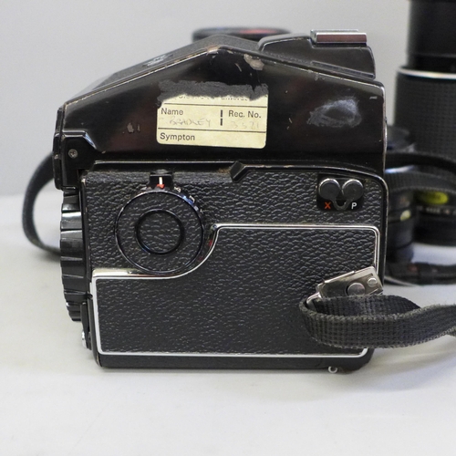 739 - A Mamiya 645 1000s medium format film camera with three lenses; 210mm, 150mm, 80mm, a range of filte... 