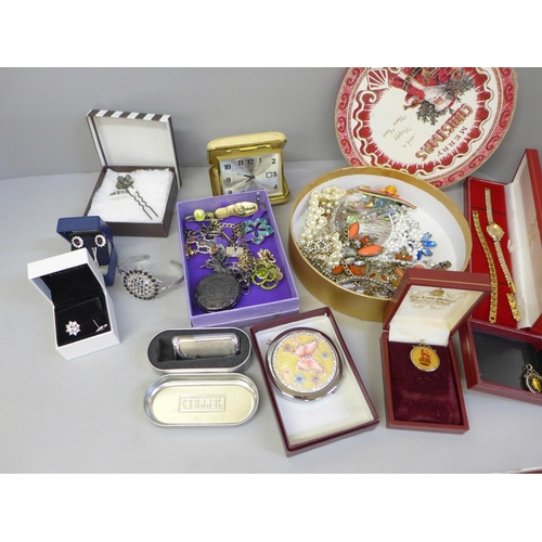 747 - A box of mixed costume jewellery, lady's wristwatch, travel clock, etc.