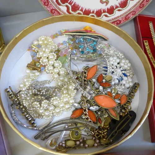 747 - A box of mixed costume jewellery, lady's wristwatch, travel clock, etc.