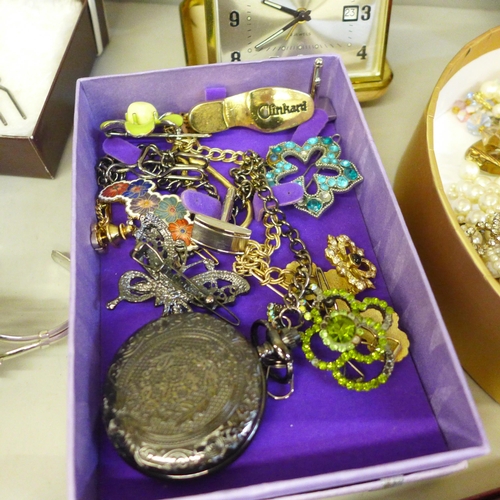 747 - A box of mixed costume jewellery, lady's wristwatch, travel clock, etc.