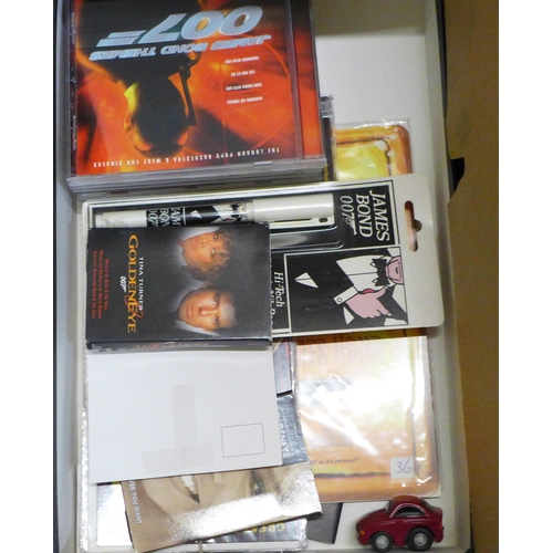 757 - A collection of James Bond films, (VHS video cassette packs) collectors discs, jumper, lobby cards, ... 