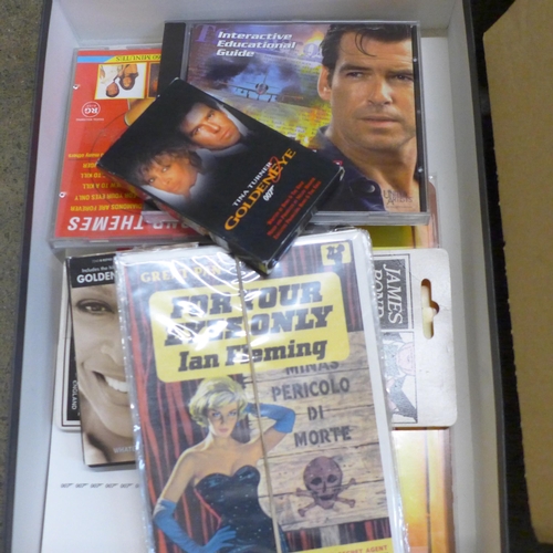 757 - A collection of James Bond films, (VHS video cassette packs) collectors discs, jumper, lobby cards, ... 