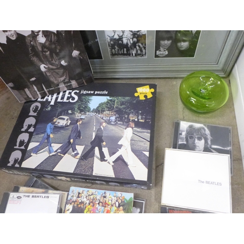 780 - A collection of The Beatles memorabilia including CDs (11), book, jigsaw puzzle, a glass apple and a... 