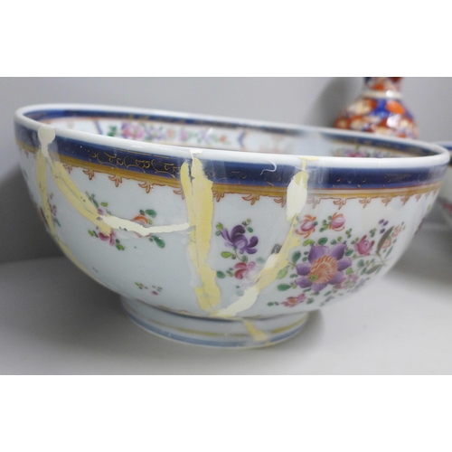 812 - Two large porcelain punch bowls, restored, an Imari vase and an Imari bowl on stand **PLEASE NOTE TH... 