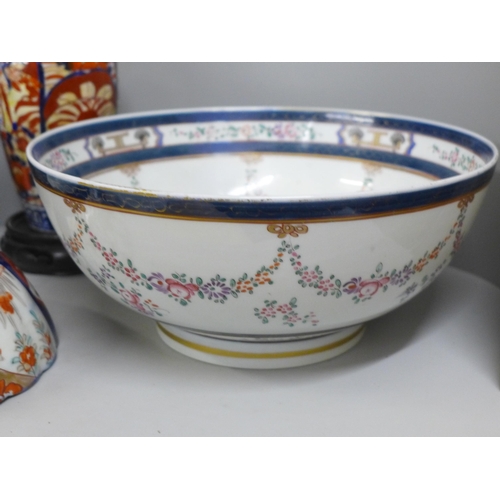 812 - Two large porcelain punch bowls, restored, an Imari vase and an Imari bowl on stand **PLEASE NOTE TH... 