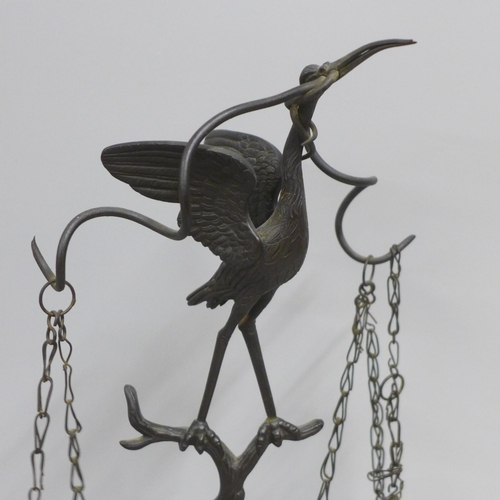 814 - A bronze 'Grand Tour' oil lamp in the form of a crane on top of a tree stump with snake entwined on ... 