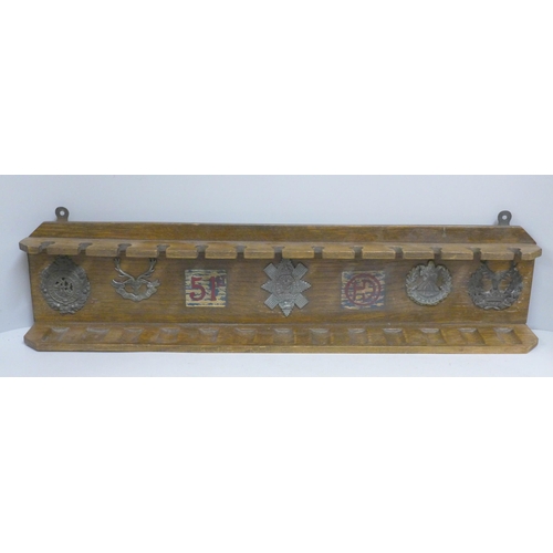 824 - An oak pipe rack, 51st Highlanders with five applied badges