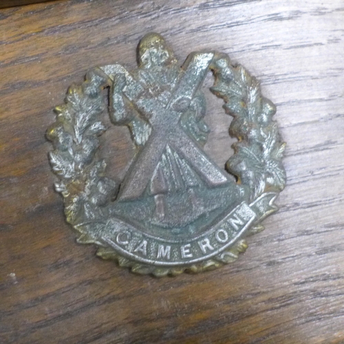 824 - An oak pipe rack, 51st Highlanders with five applied badges