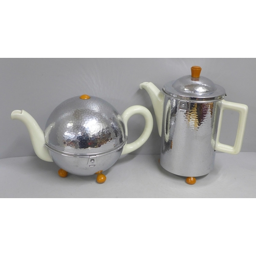 826 - A planished steel covered tea pot and hot water jug