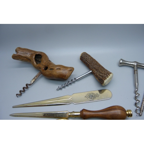 887 - A collection of corkscrews, paper knives, implements, etc.