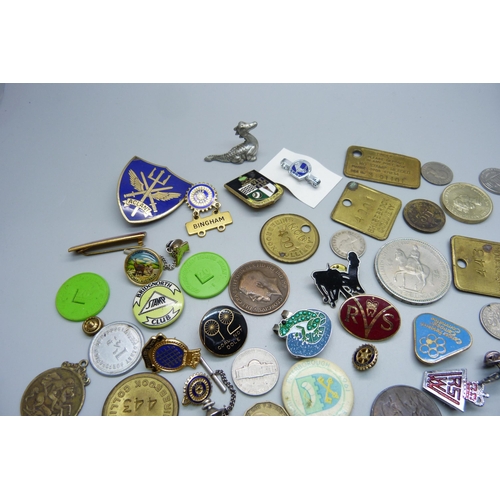 893 - A collection of tokens, pin badges and coins