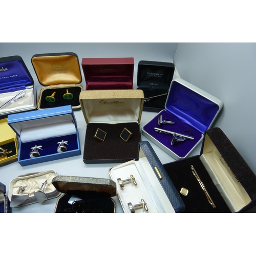 938 - A collection of cufflinks and tie-pins, boxed