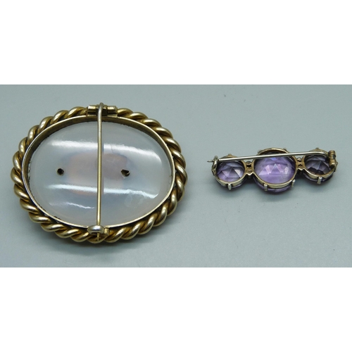 957 - A brooch set with three amethysts and seed pearls and one other brooch, (lacking one seed pearl)