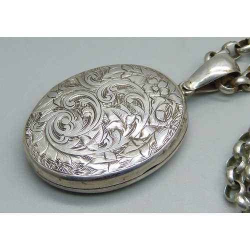 960 - A locket on a silver chain, chain 74cm