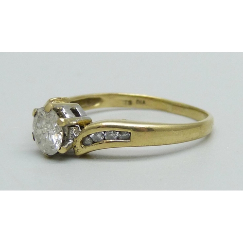 968 - An 18ct gold and diamond solitaire ring with diamond shoulders, approximately 0.60ct diamond weight,... 