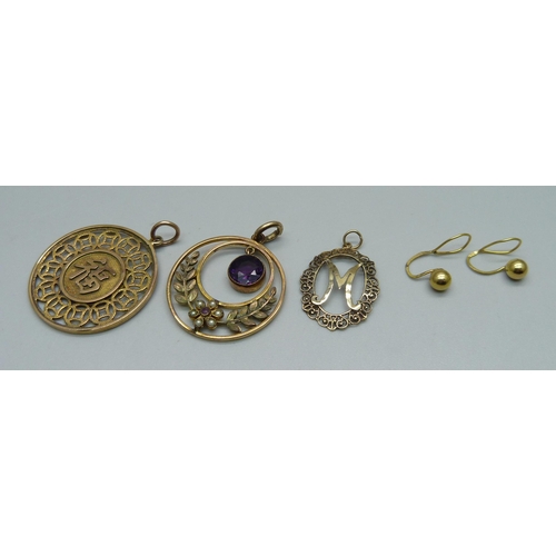 970 - A 14k gold Chinese pendant, 3.9g, (marked on outer rim), two other pendants and a pair of earrings