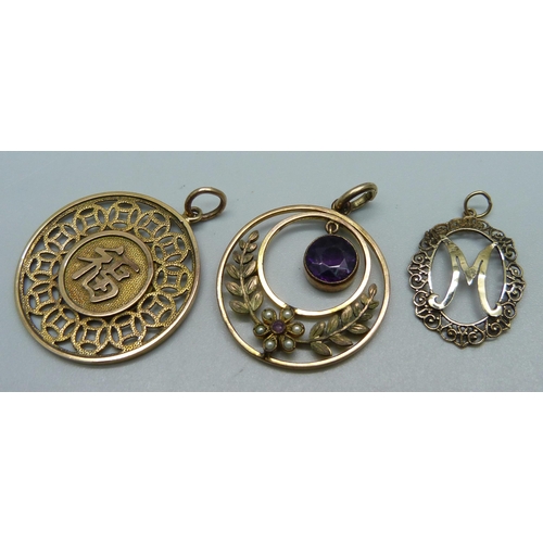 970 - A 14k gold Chinese pendant, 3.9g, (marked on outer rim), two other pendants and a pair of earrings