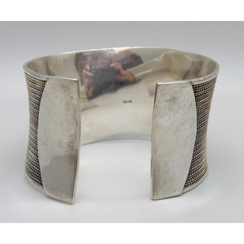 975 - A heavy silver bangle, 74g