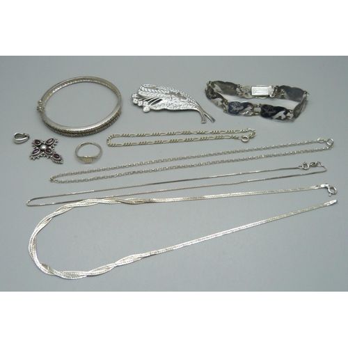 986 - Three silver necklaces, two silver bracelets, a silver brooch and ring, a silver bangle (one stone m... 