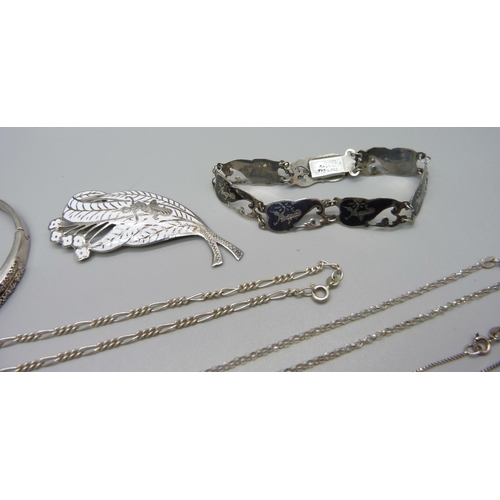 986 - Three silver necklaces, two silver bracelets, a silver brooch and ring, a silver bangle (one stone m... 