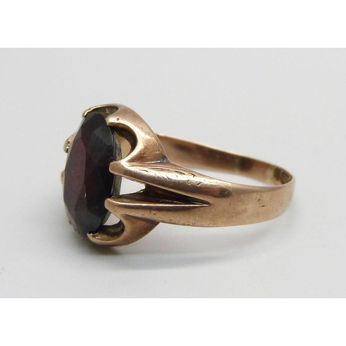 987 - A 9ct gold ring set with a garnet, 4g, Q, a silver child's bangle and two small silver child's size ... 