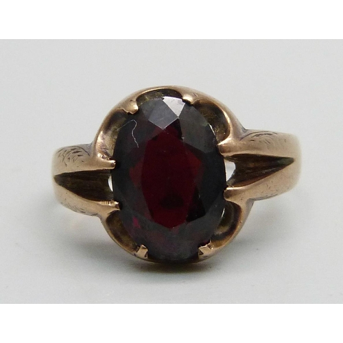 987 - A 9ct gold ring set with a garnet, 4g, Q, a silver child's bangle and two small silver child's size ... 