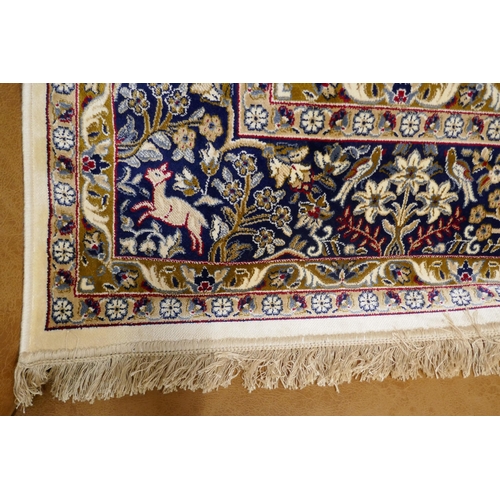 1447 - An ivory ground Cashmere carpet, traditional tree of life design, 200cm x 300cm