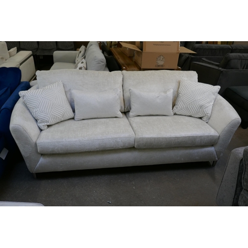 1513 - An ivory upholstered three seater sofa on steel legs