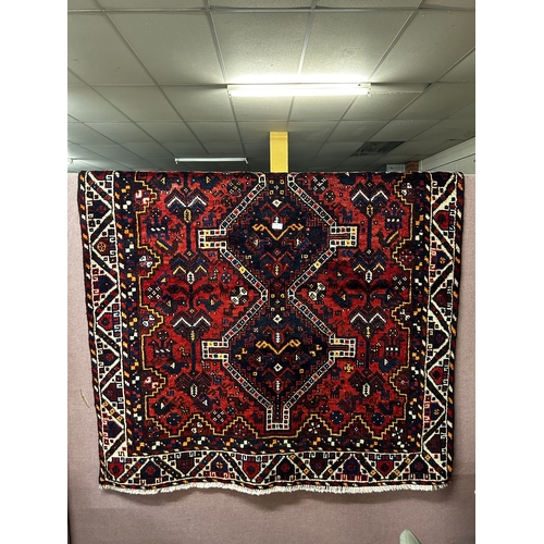 1572 - A rich red ground Persian Qashqai Nomadic rug, traditional design, 187cm x 144cm