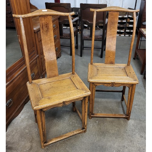 207 - A pair of 19th Century Chinese elm yoke back chairs