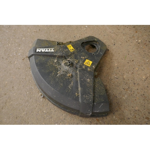 2215 - A petrol driven Titan TT5MTP26-2 multi tool with multiple attachments including hedge cutter, chains... 