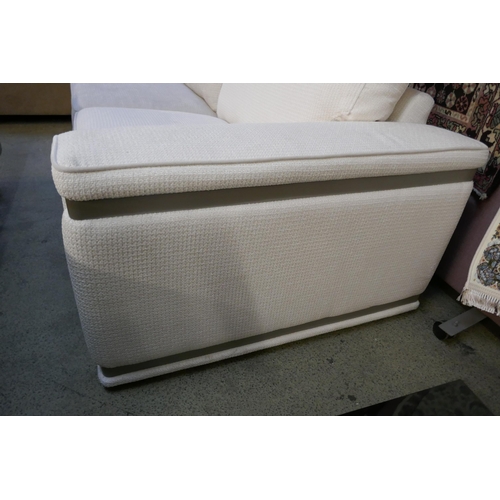 1541 - A cream upholstered three seater sofa with steel trim - differing fabric batches on each section