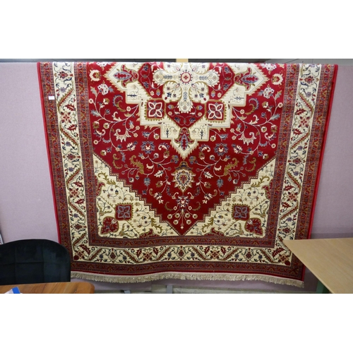 1549 - A rich red ground Cashmere carpet, full pile, floral medallion design, 200cm x 300cm