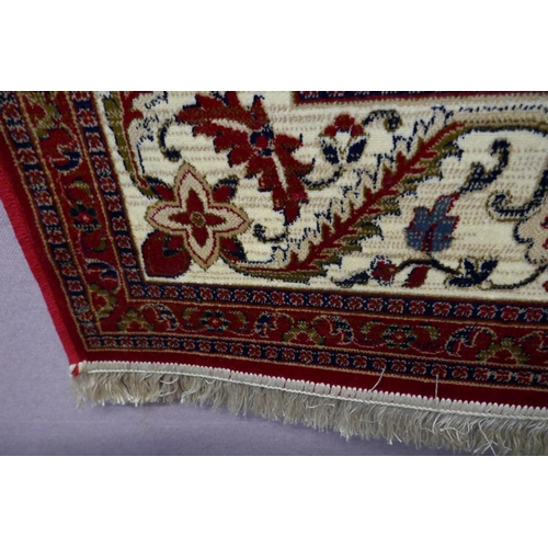 1549 - A rich red ground Cashmere carpet, full pile, floral medallion design, 200cm x 300cm