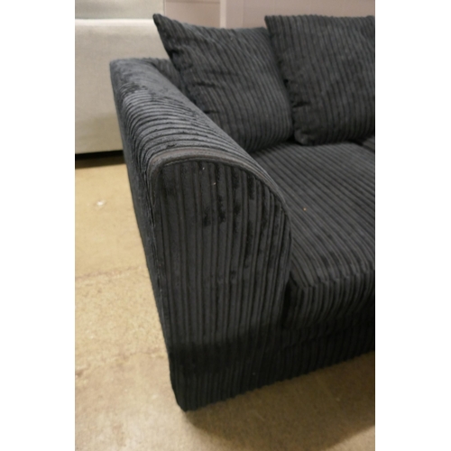 1590 - A black jumbo cord two seater sofa