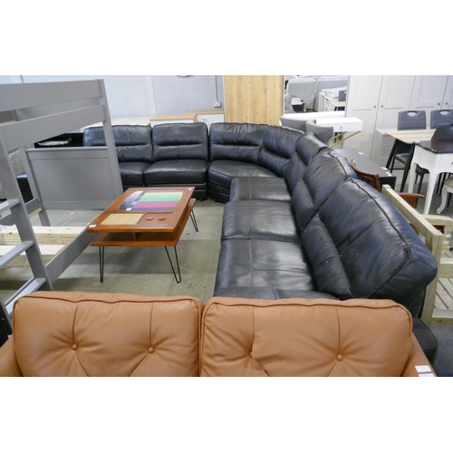 1600 - A black upholstered and leather large corner sofa