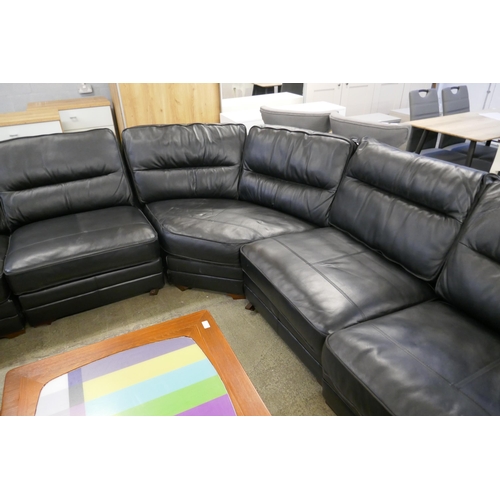 1600 - A black upholstered and leather large corner sofa