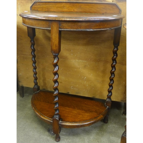 134 - An early 20th Century oak barleytwist demi-lune hall table