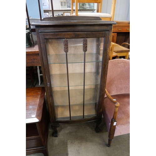 197 - An oak bow front single door display cabinet