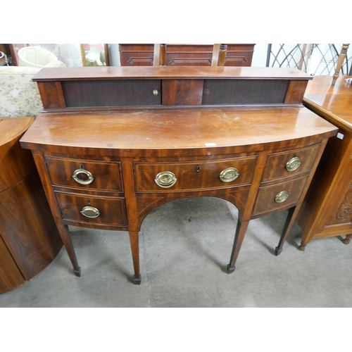 202 - A George III mahogany bow front sideboard